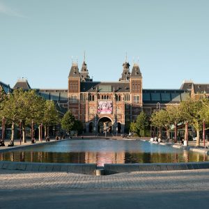 people walking on park near brown building during daytime